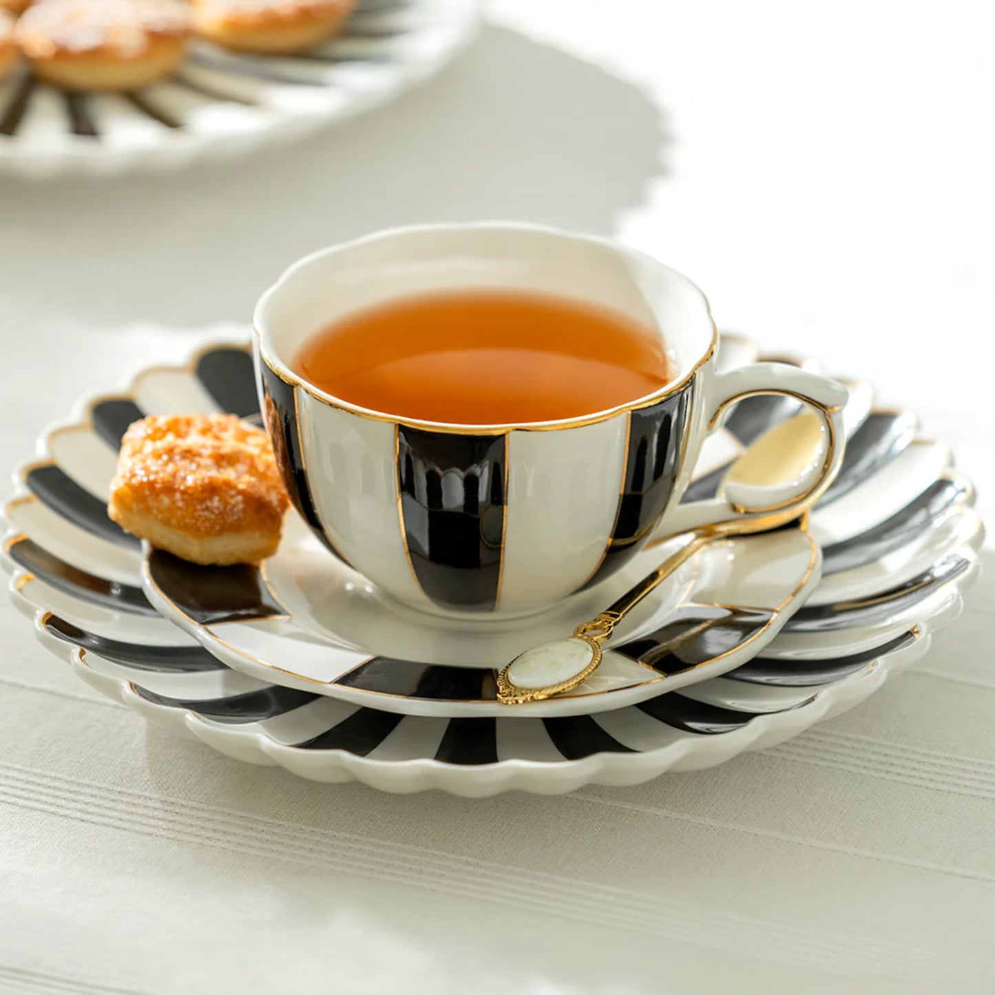 Black and White Striped Scallop Porcelain Tea Cup and Saucer with Gold Trim